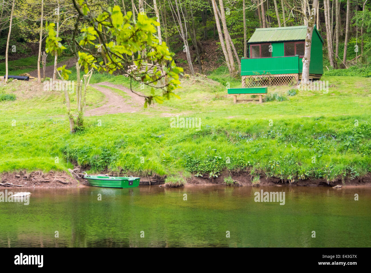 A fishing hut and boat on the banks of the River Eden, south of Wetherall, Cumbria, UK. Stock Photo