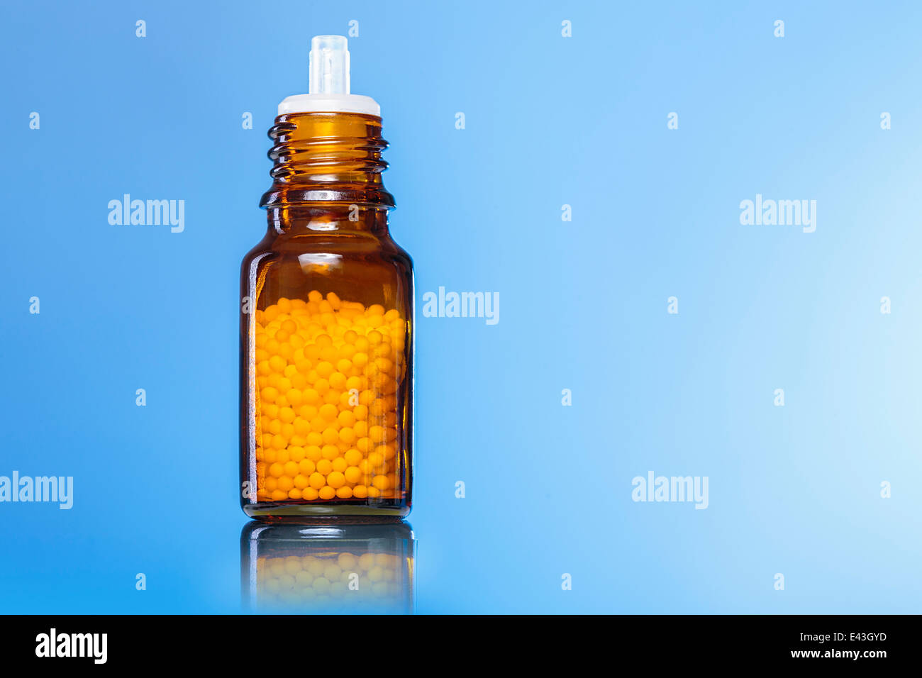 single bottle with homeopathy globules with blue background Stock Photo ...
