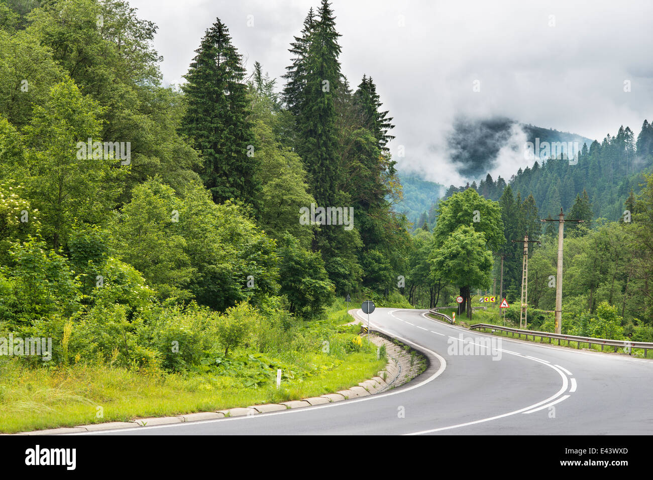 Sinuous Road in Mountains, cloudscape scenery Stock Photo