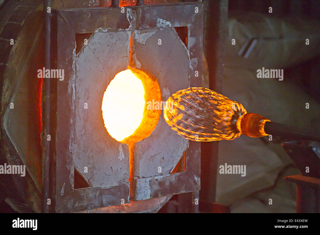Molten glass being shaped in a forge Stock Photo