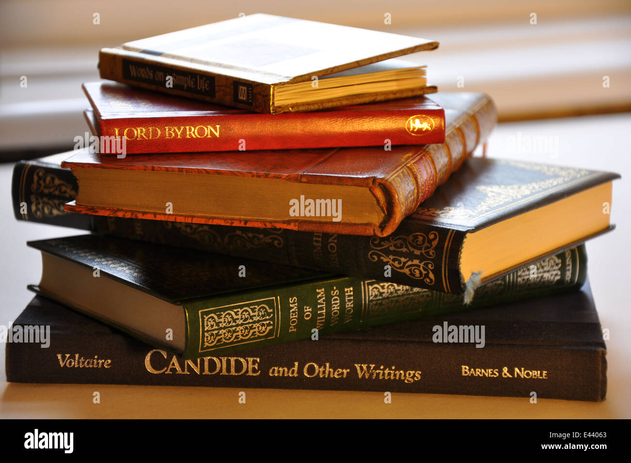 A Stack of Classical Books by the Window Stock Photo