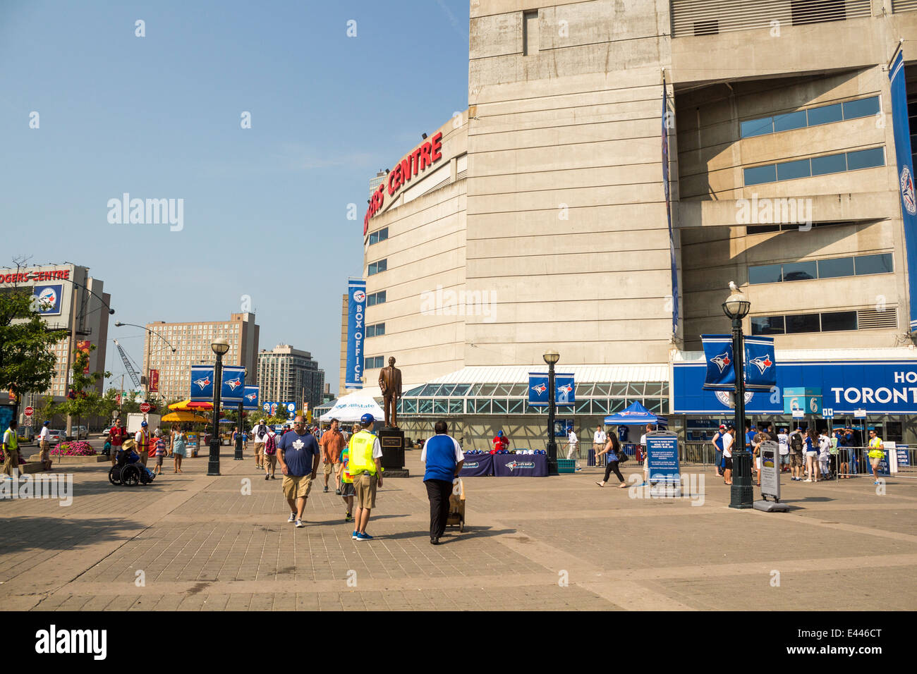 People walking around outside the Roger's Centre before a Toronto Blue Jay's baseball game on a summy summer day Stock Photo