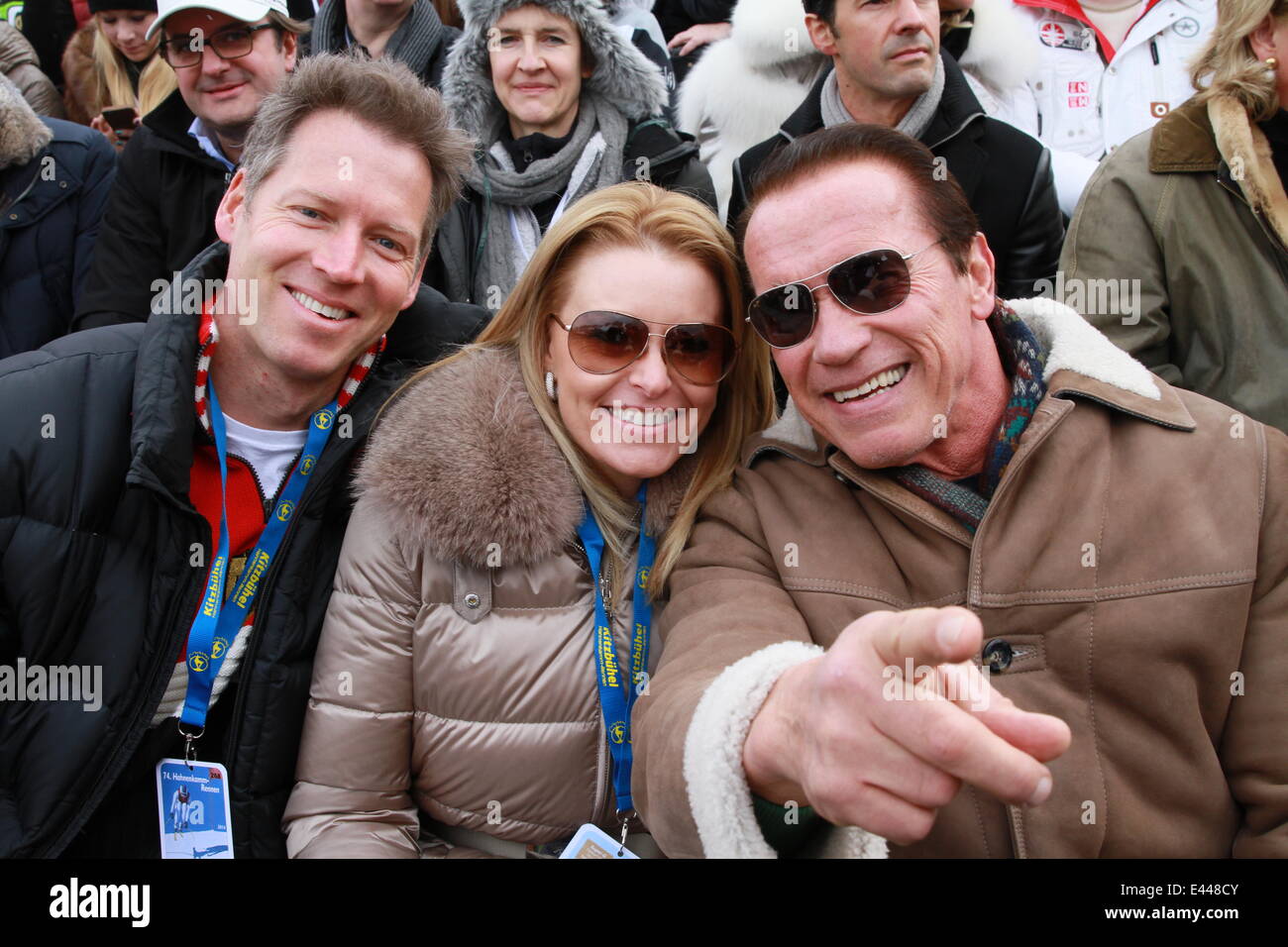 Arnold Schwarzenegger and girlfriend Heather Milligan sitting in the VIP grandstand at the 2014 FIS Alpine World Cup  Featuring: Arnold Schwarzenegger,Heather Milligan Where: Kitzbuehel, Austria When: 25 Jan 2014 Stock Photo