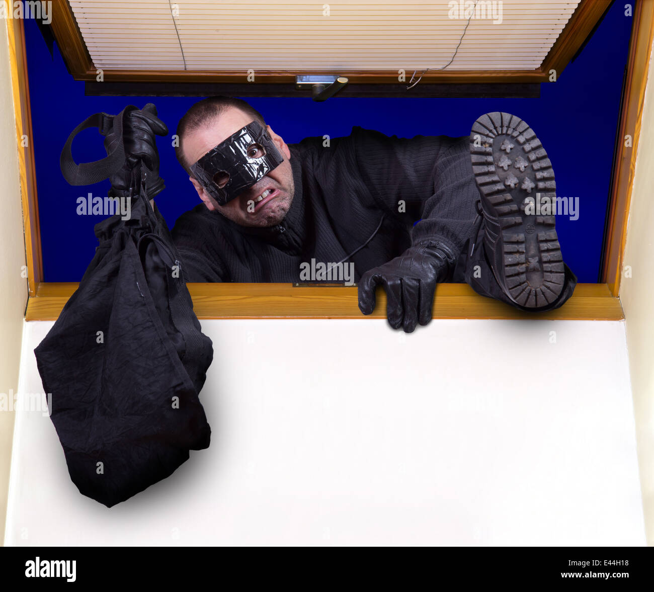 A robber enters the house through the roof window Stock Photo Alamy