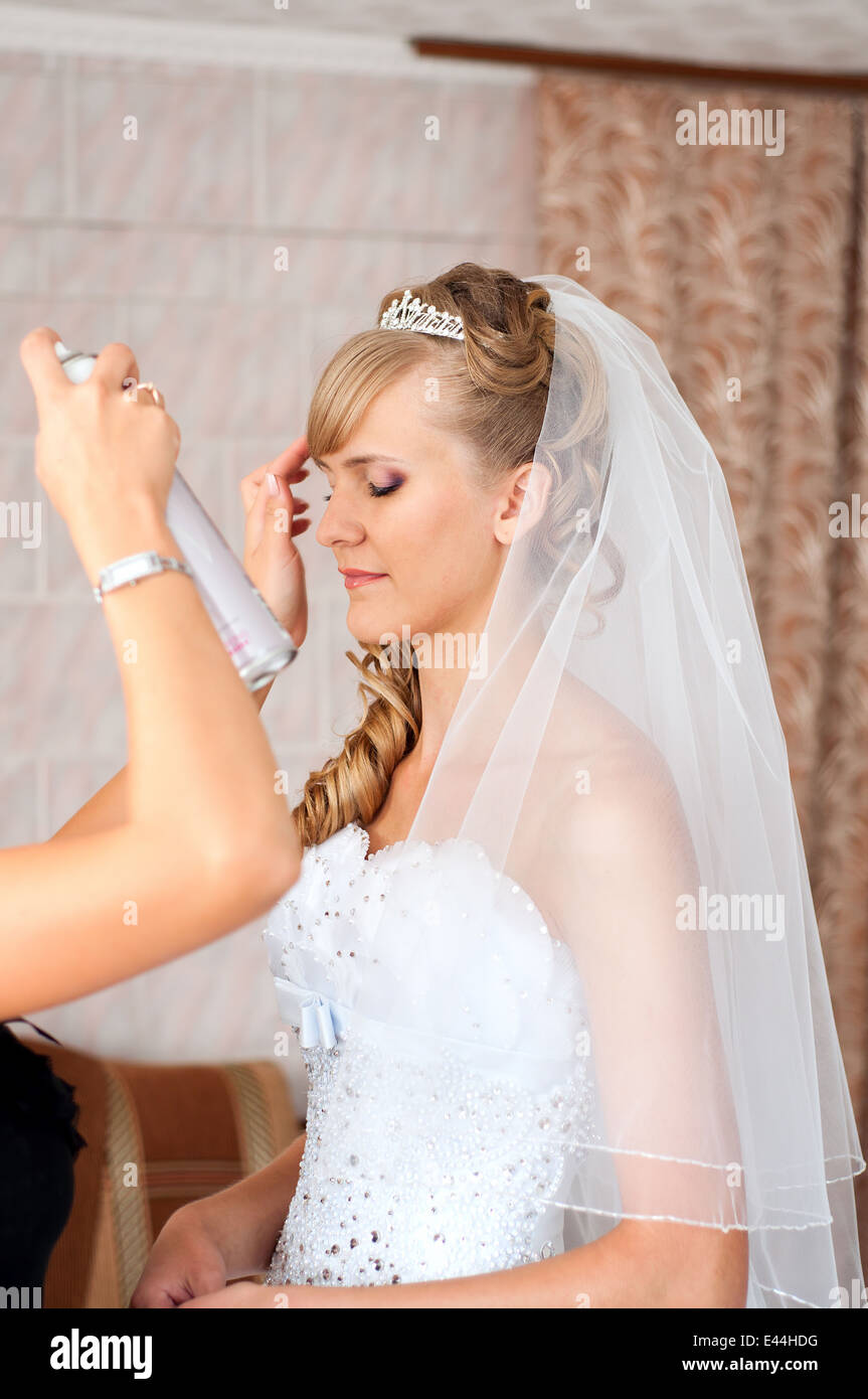 Hairdresser makes bride's hairstyle Stock Photo