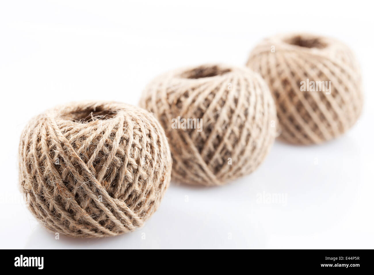 Three balls of twine with focus on front twine ball. Stock Photo