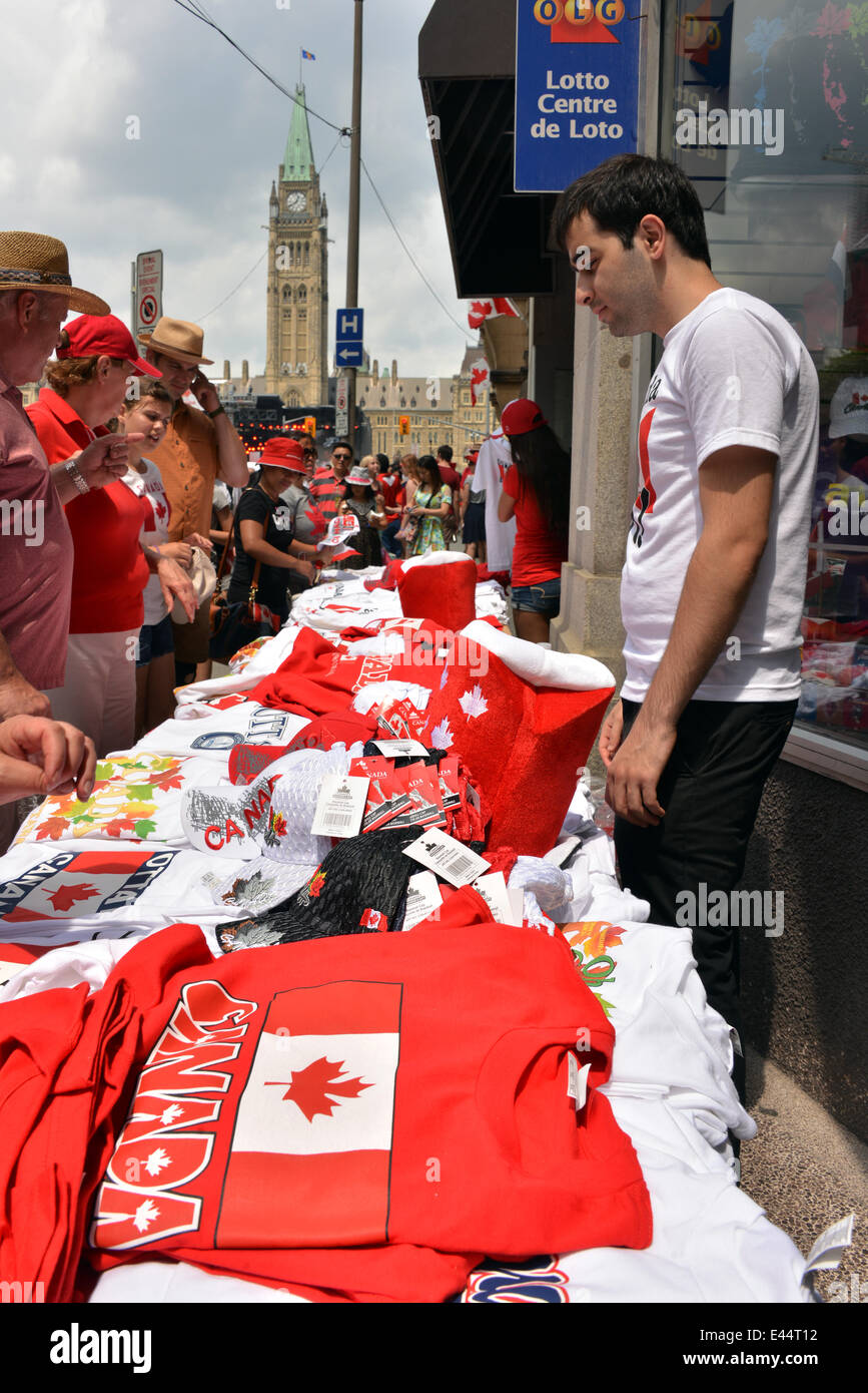 Ottawa, Canada. July 1st, 2014.  Vendor sells Canada related goods to the thousands of people who visit Parliament Hill in Ottawa for Canada Day. © Paul McKinnon/Alamy Live News Stock Photo