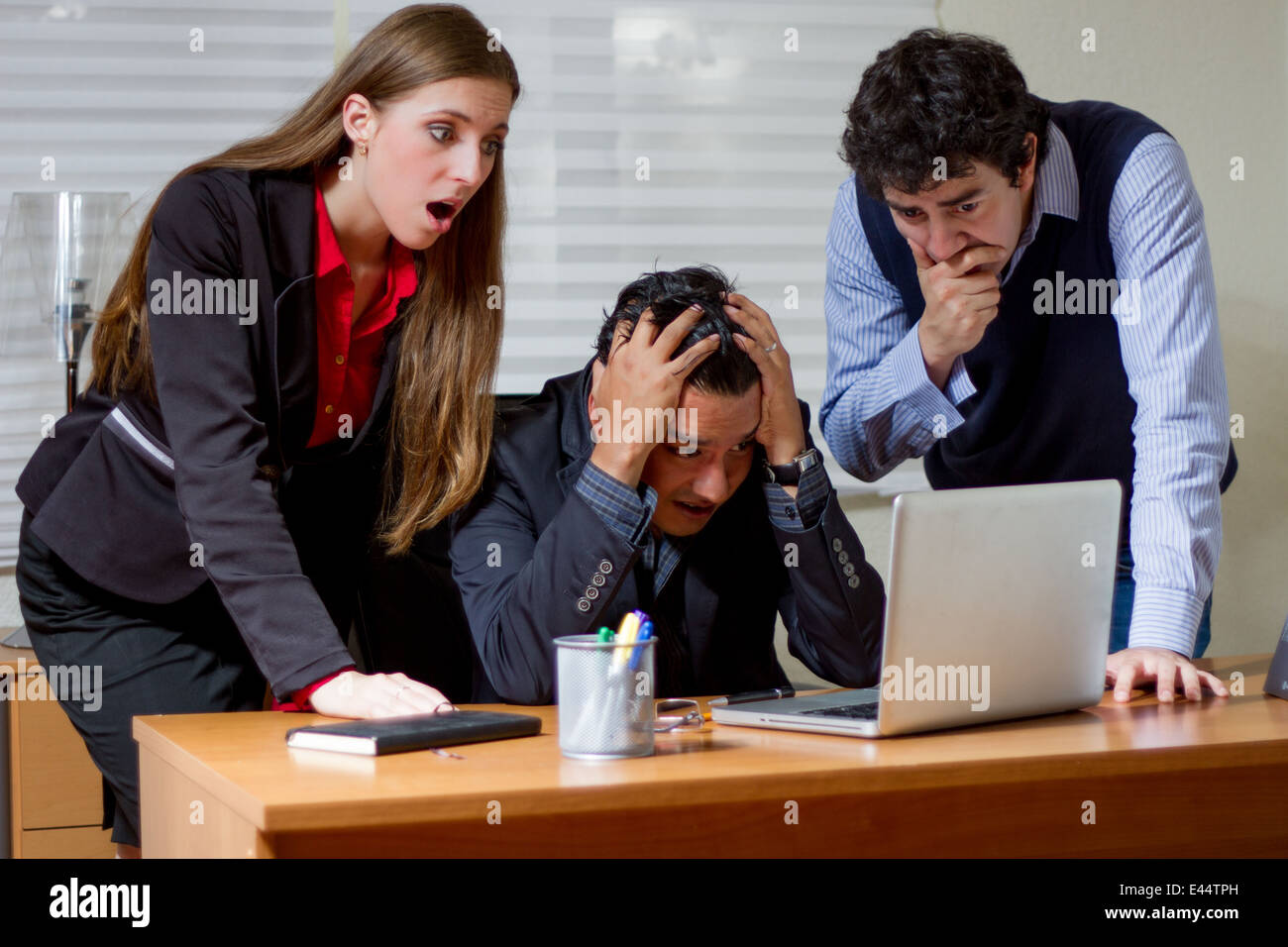 Three co-workers find out a very bad news Stock Photo