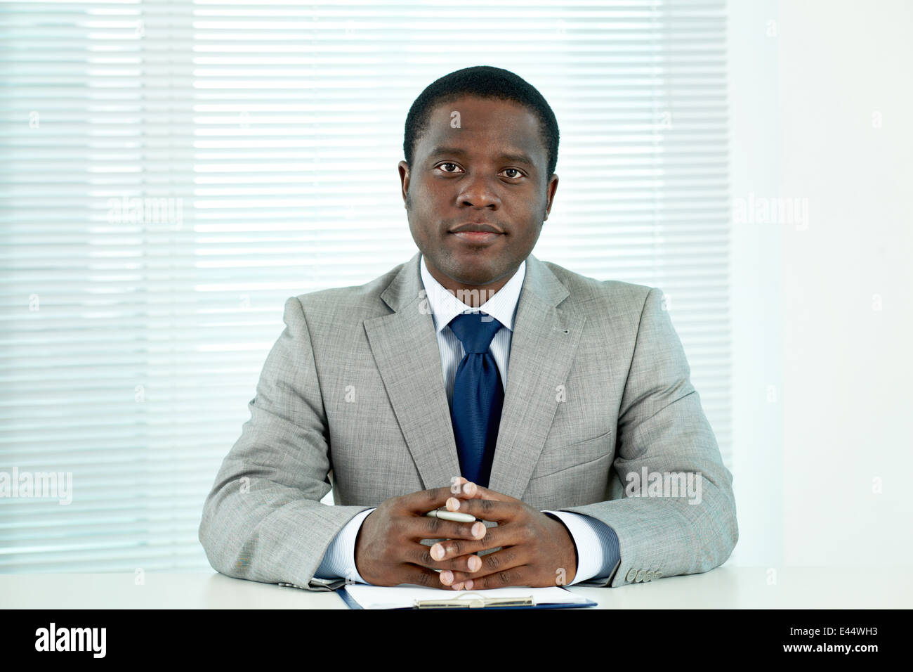 Portrait of confident African businessman looking at camera in office ...