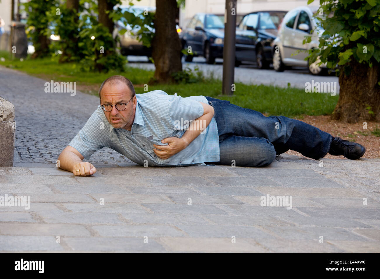 A man has a dizzy spell or a heart attack Stock Photo