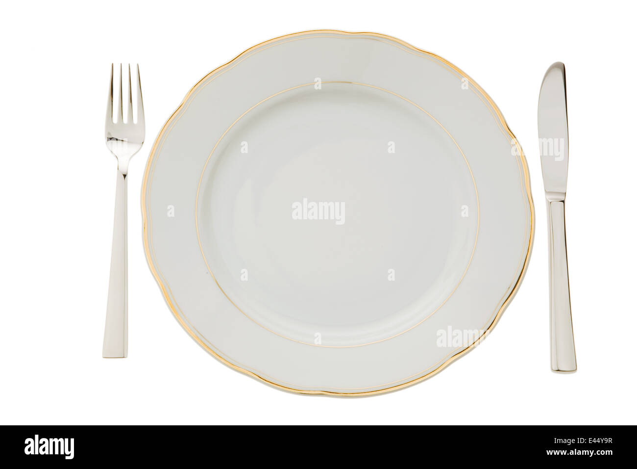 A knife with a fork and plate. Place setting for a dinner at the ...
