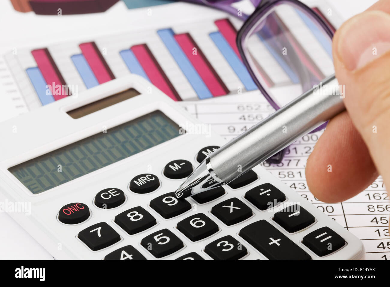 A calculator with graphics of a balance sheet. Sales, profit and