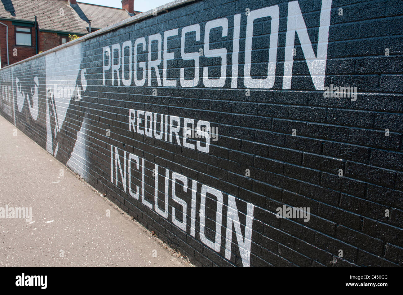 Mural on a wall in Carrickfergus 'Pregression requires Inclusion', after loyalists feel they are being omitted from power. Stock Photo