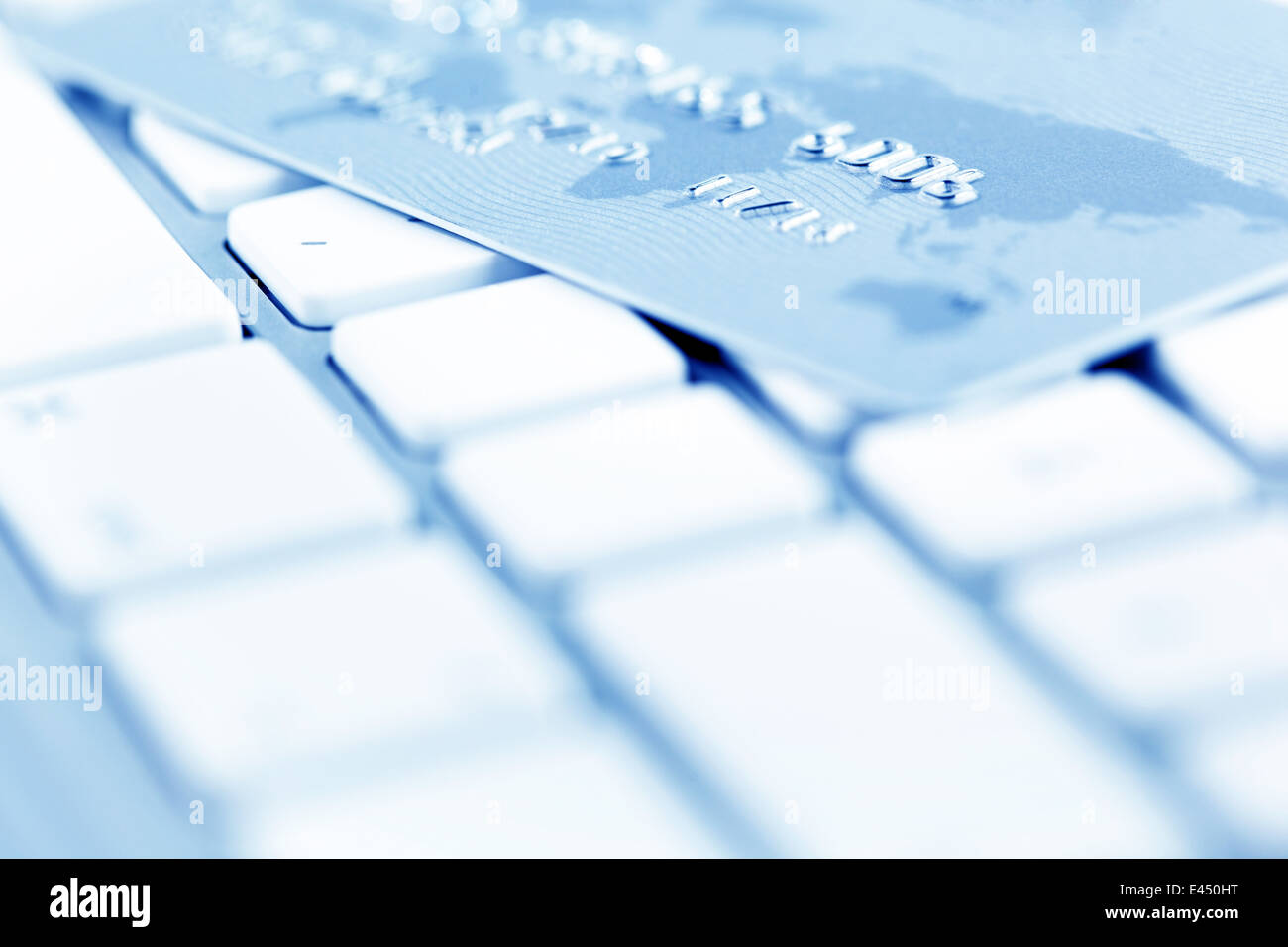On the keyboard of a computer is a credit card. Online banking and ...