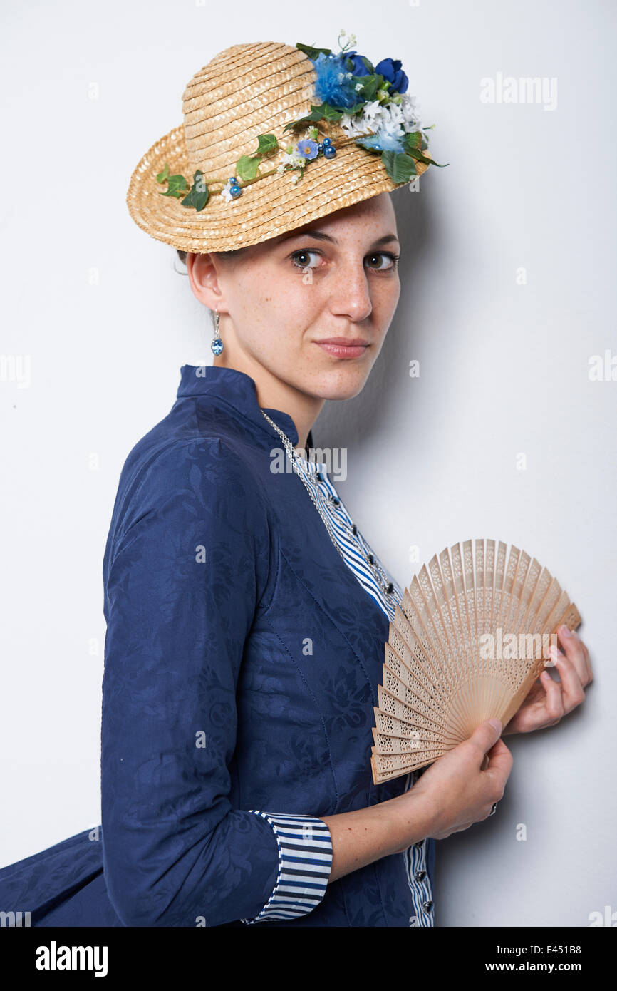 Young woman with hat and fan Stock Photo