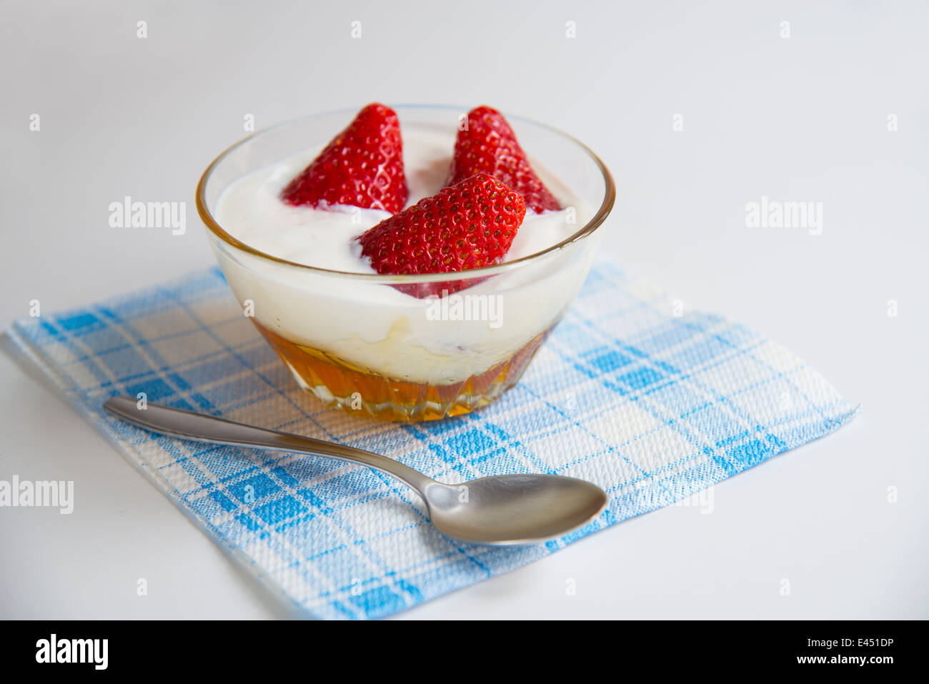 Healthy dessert: strawberries with yoghurt cream and honey. Close view. Stock Photo