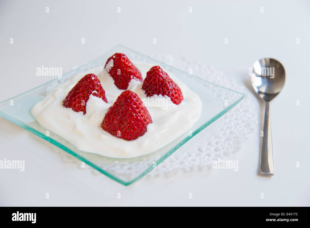 Dessert: strawberries with cream. Close view. Stock Photo