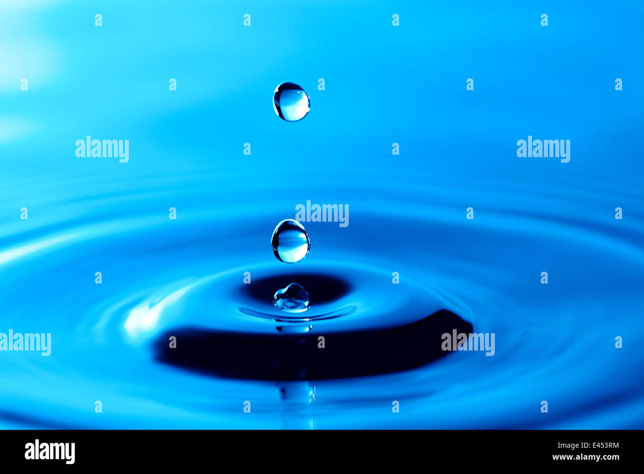 Splash of water crown on blue surface Stock Photo - Alamy