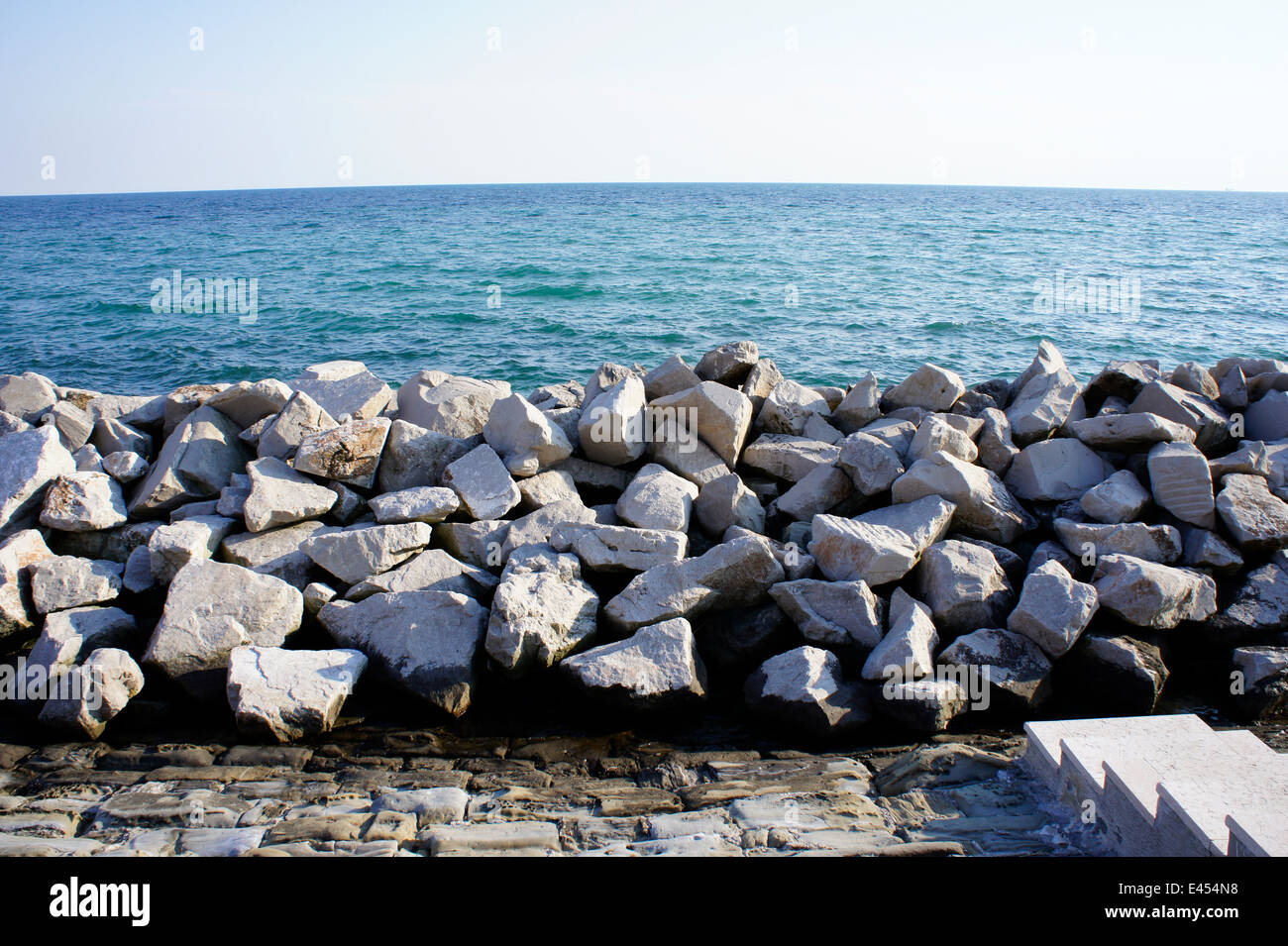 Rocky sea wall, a defence against the sea, at Grado, northern Italy Stock Photo