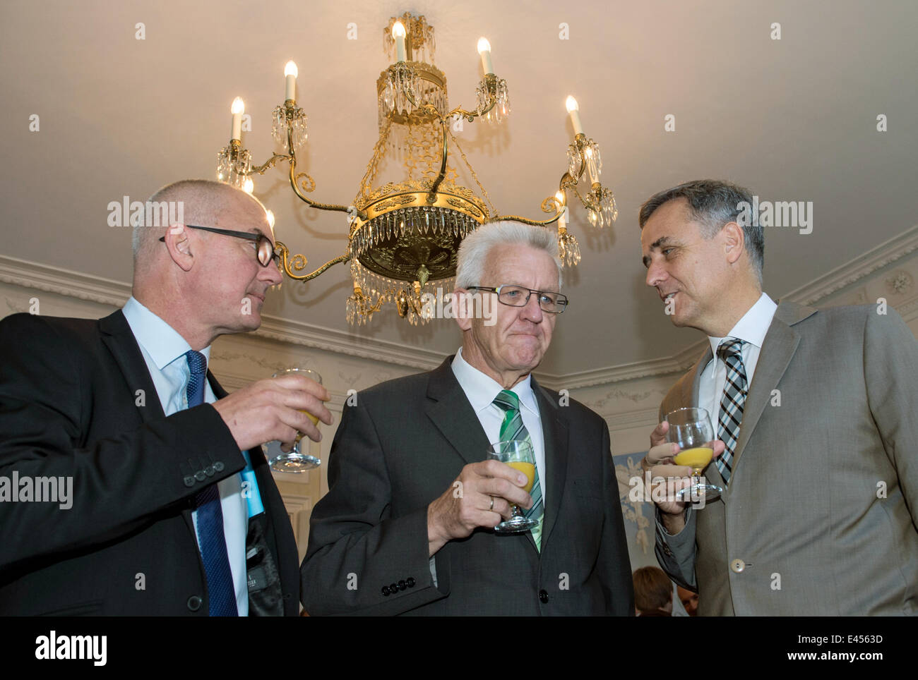 Sissach, Switzerland. 03rd July, 2014. Premier of Baden-Wuerttemberg Winfried Kretschmann (C) speaks with Isaac Reber (L), governor of the canton Basel-Land and Guy Morin (R), governor of the canton Basel-Stadt at Ebenrain Palace in Sissach, Switzerland, 03 July 2014. Kretschmann is on a three-day trip to the region. Photo: PATRICK SEEGER/dpa/Alamy Live News Stock Photo