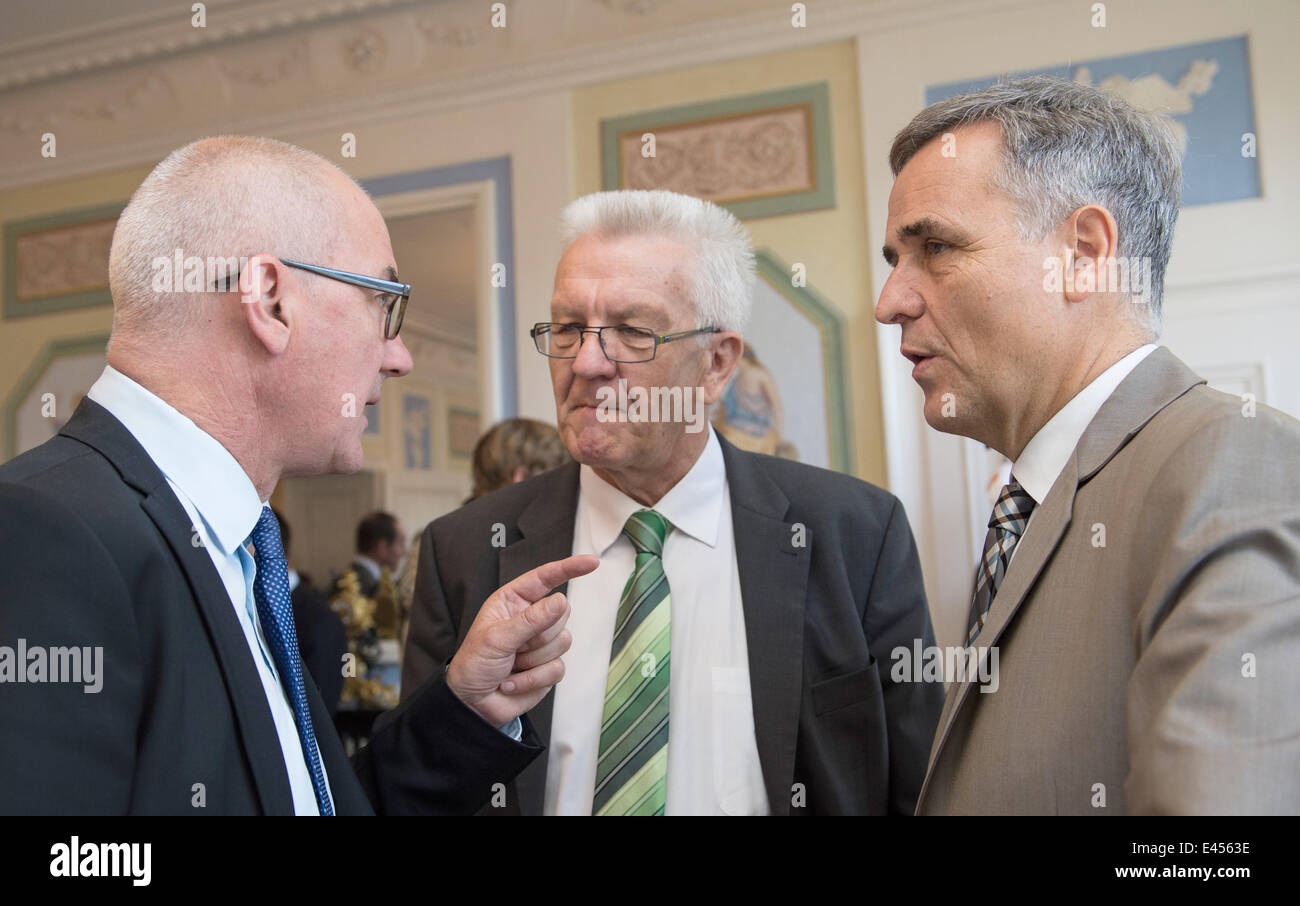 Sissach, Switzerland. 03rd July, 2014. Premier of Baden-Wuerttemberg Winfried Kretschmann (C) speaks with Isaac Reber (L), governor of the canton Basel-Land and Guy Morin (R), governor of the canton Basel-Stadt at Ebenrain Palace in Sissach, Switzerland, 03 July 2014. Kretschmann is on a three-day trip to the region. Photo: PATRICK SEEGER/dpa/Alamy Live News Stock Photo