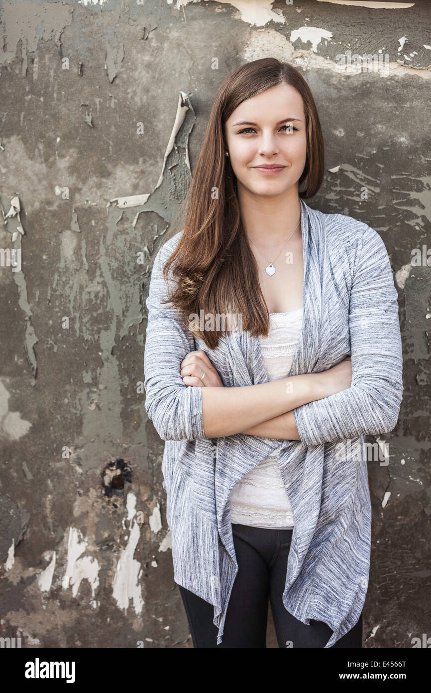 Teenage girl leaning against wall Stock Photo