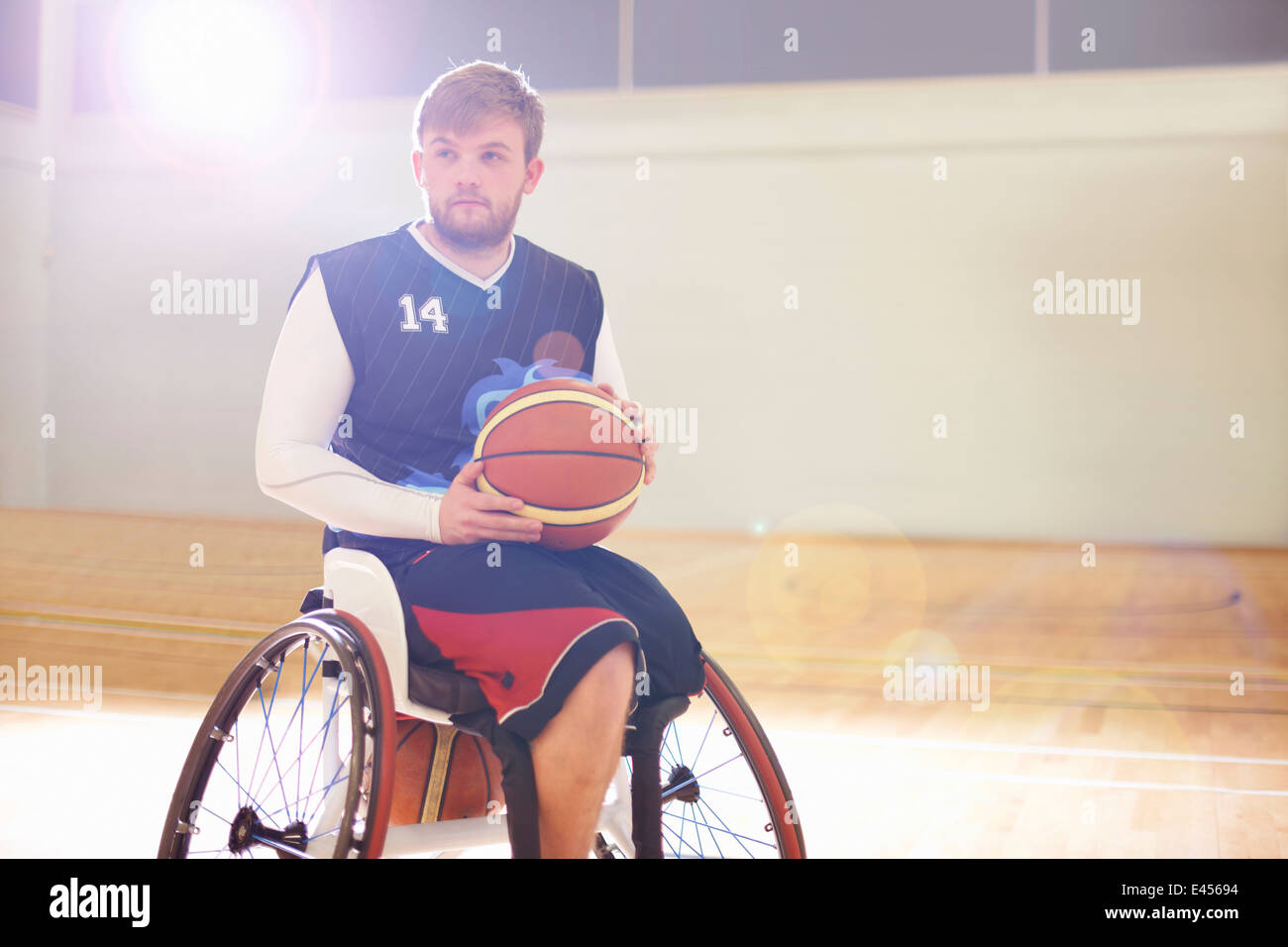 Wheelchair basketball player holding ball Stock Photo