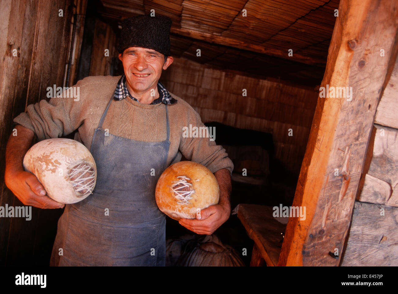 Shepherd with cheeses, Carpathian mtns, Transylvania, Romania Stock Photo