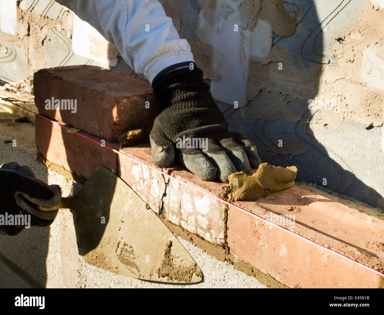 Laying bricks hands hires stock photography and images Alamy