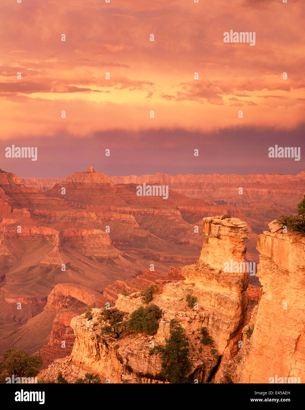 Sunset at Yaki Point on the South Rim with stratified rim rocks and minute storm clouds inside the canyon below, Grand Canyon National Park, Arizona, USA. Stock Photo