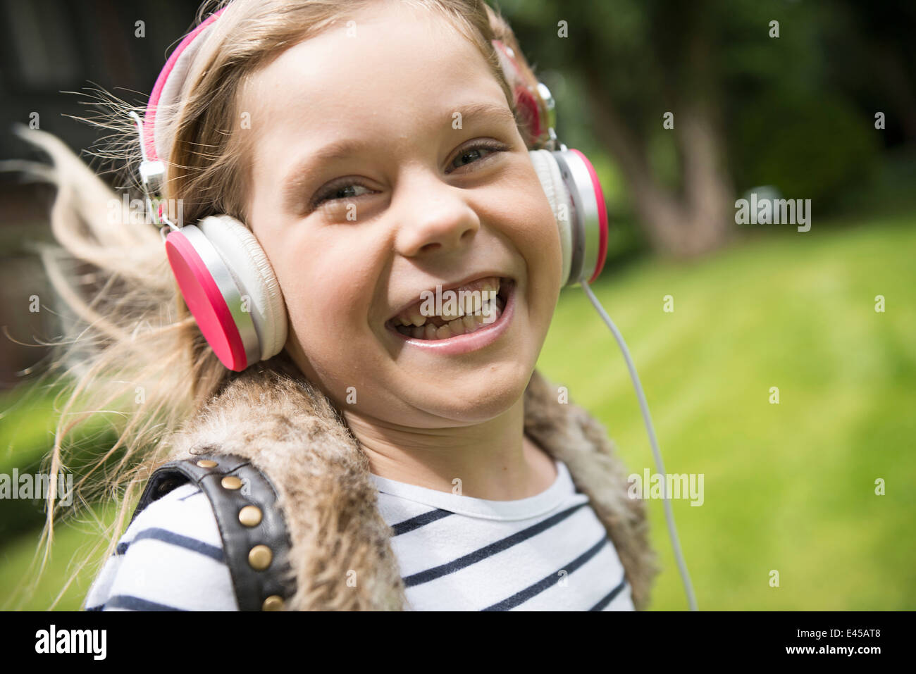 Girl listening to music on headphones Stock Photo