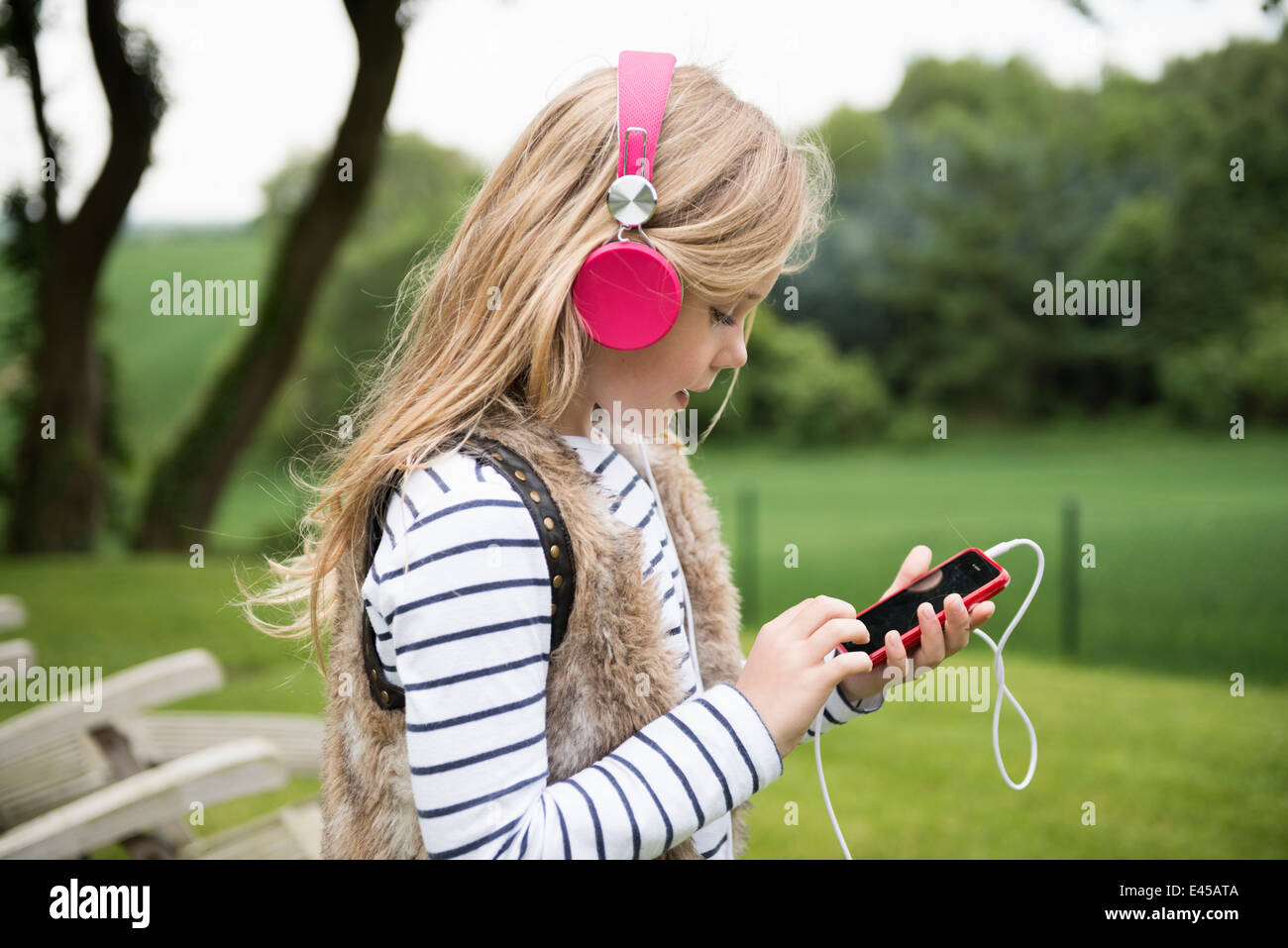 Girl listening to music on headphones Stock Photo