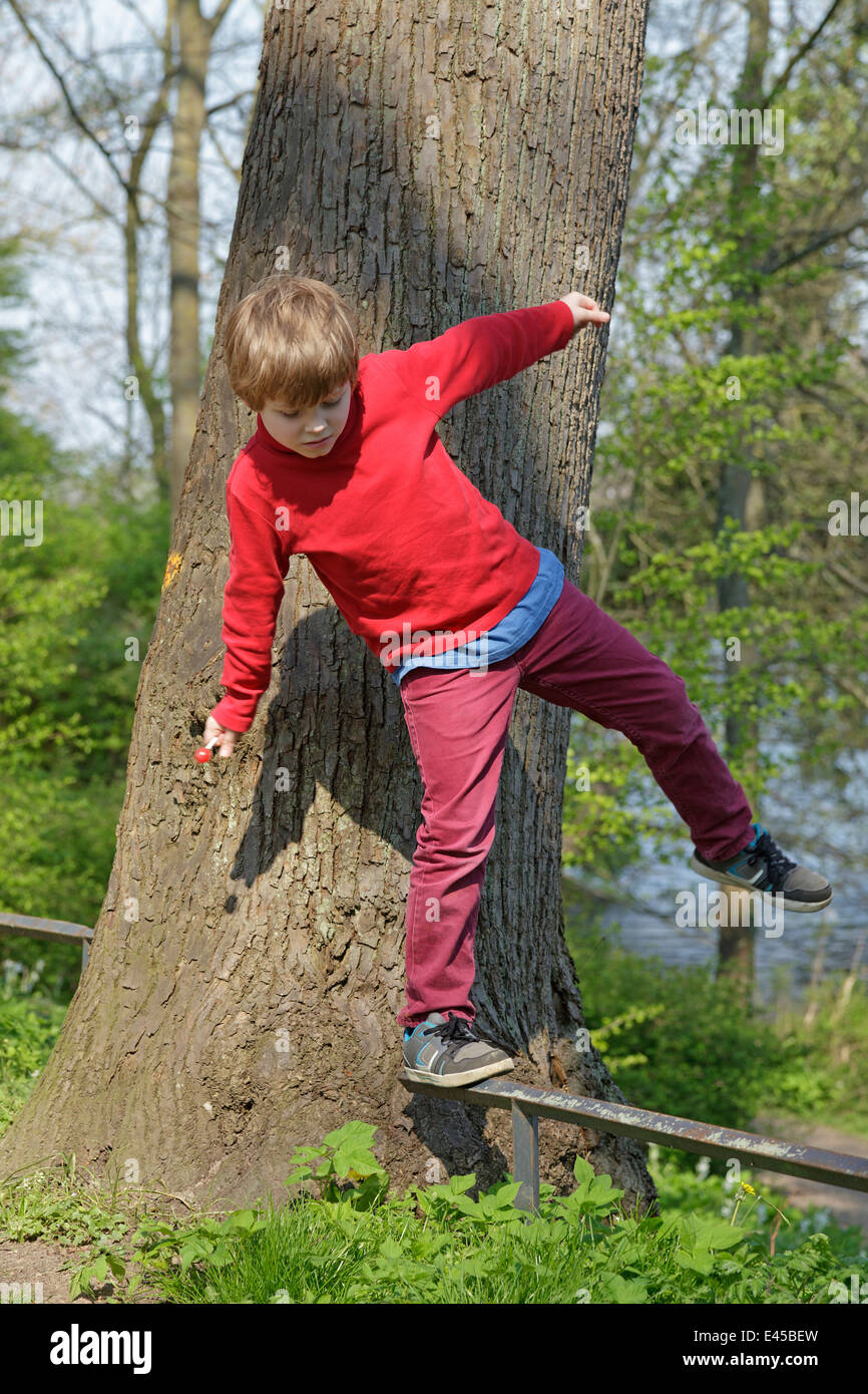 Balancing On Railing young boy balancing along a railing Stock Photo - Alamy