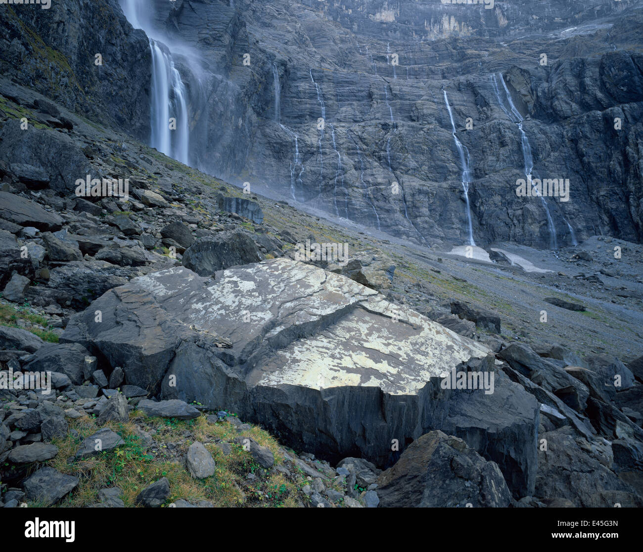 Waterfalls flowing down rock faces in the Cirque de Gavarnie, Pyrenees, France, October 2008 Stock Photo