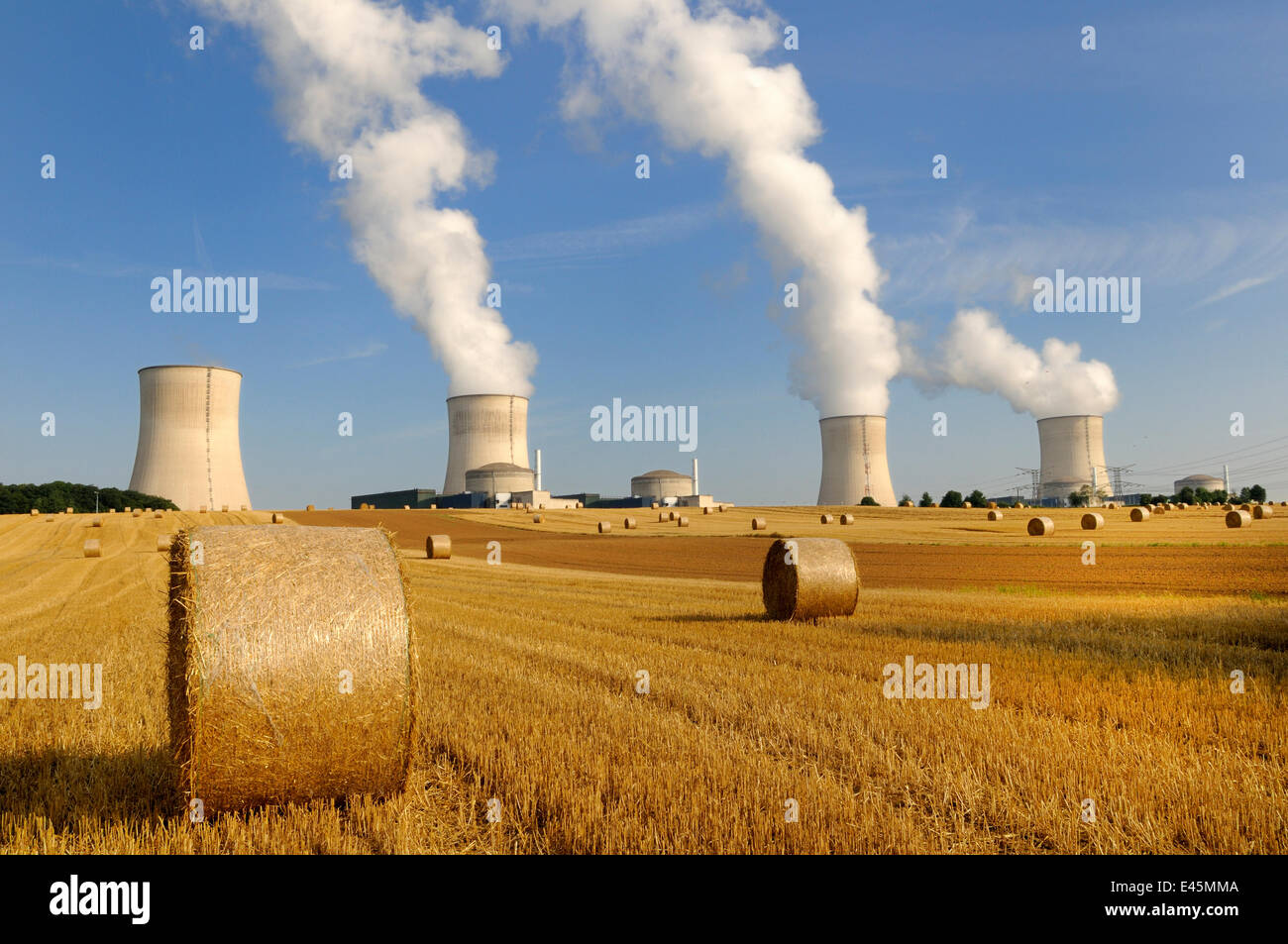 Cooling towers of Nuclear power station with farmland and straw bales in  the foreground, Cattenom, France Stock Photo - Alamy