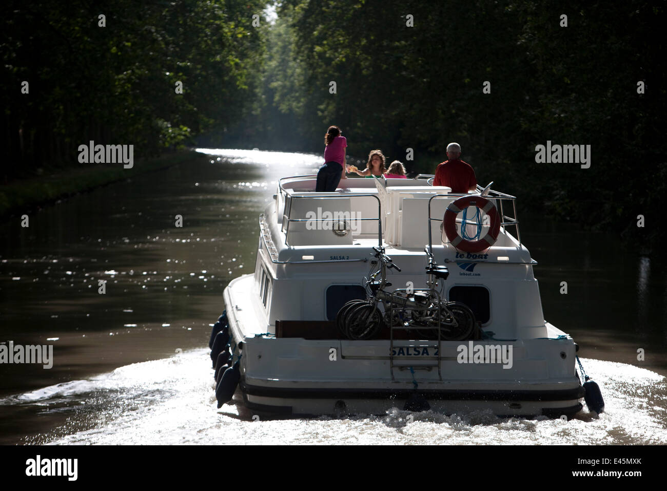 Family cruising on the Canal Du Midi near Capestang, Languedoc, France. July 2009. Model and property released. Stock Photo