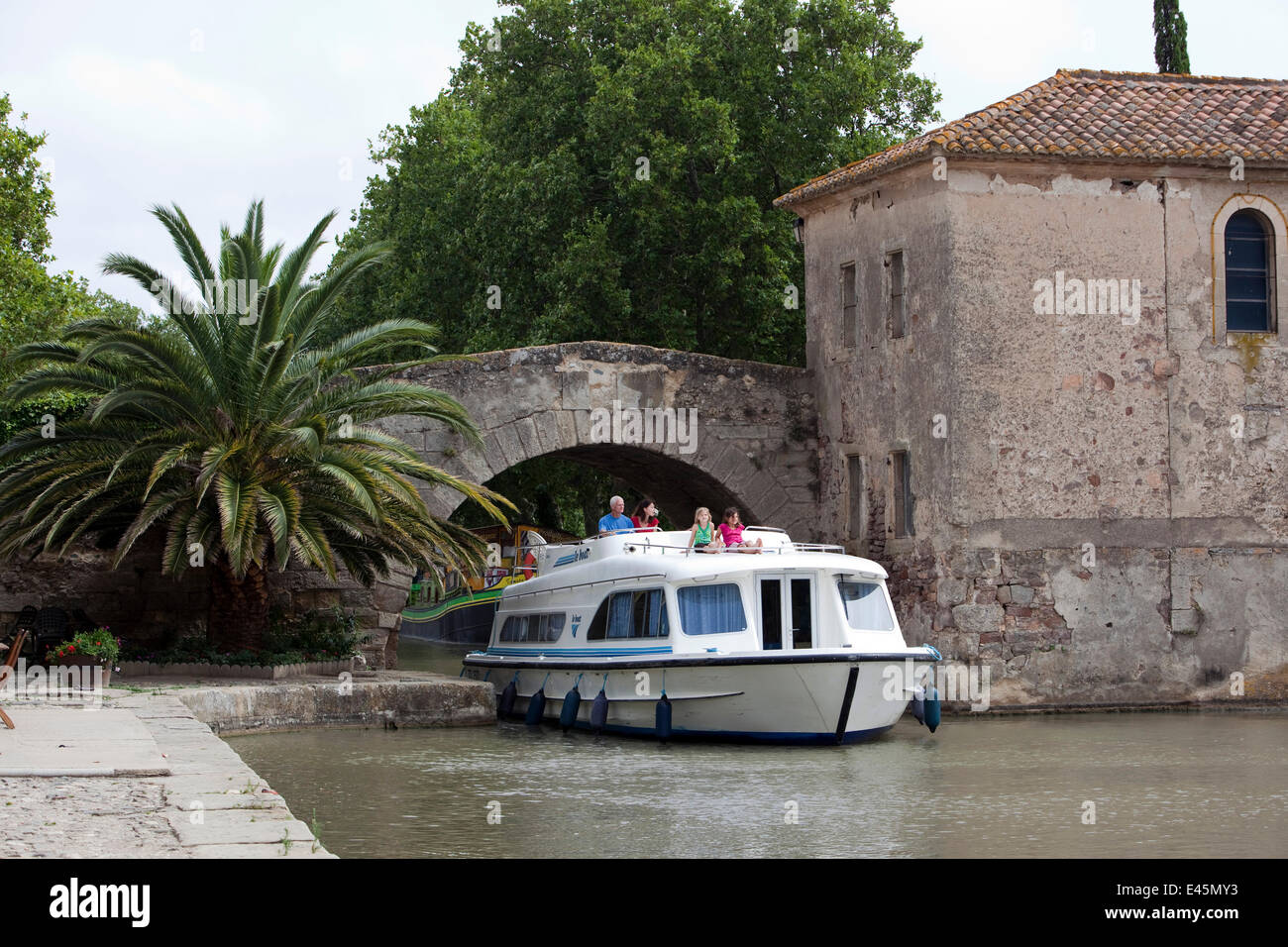 Family cruising on the Canal Du Midi, Le Somail, France. July 2009. Model released. Stock Photo