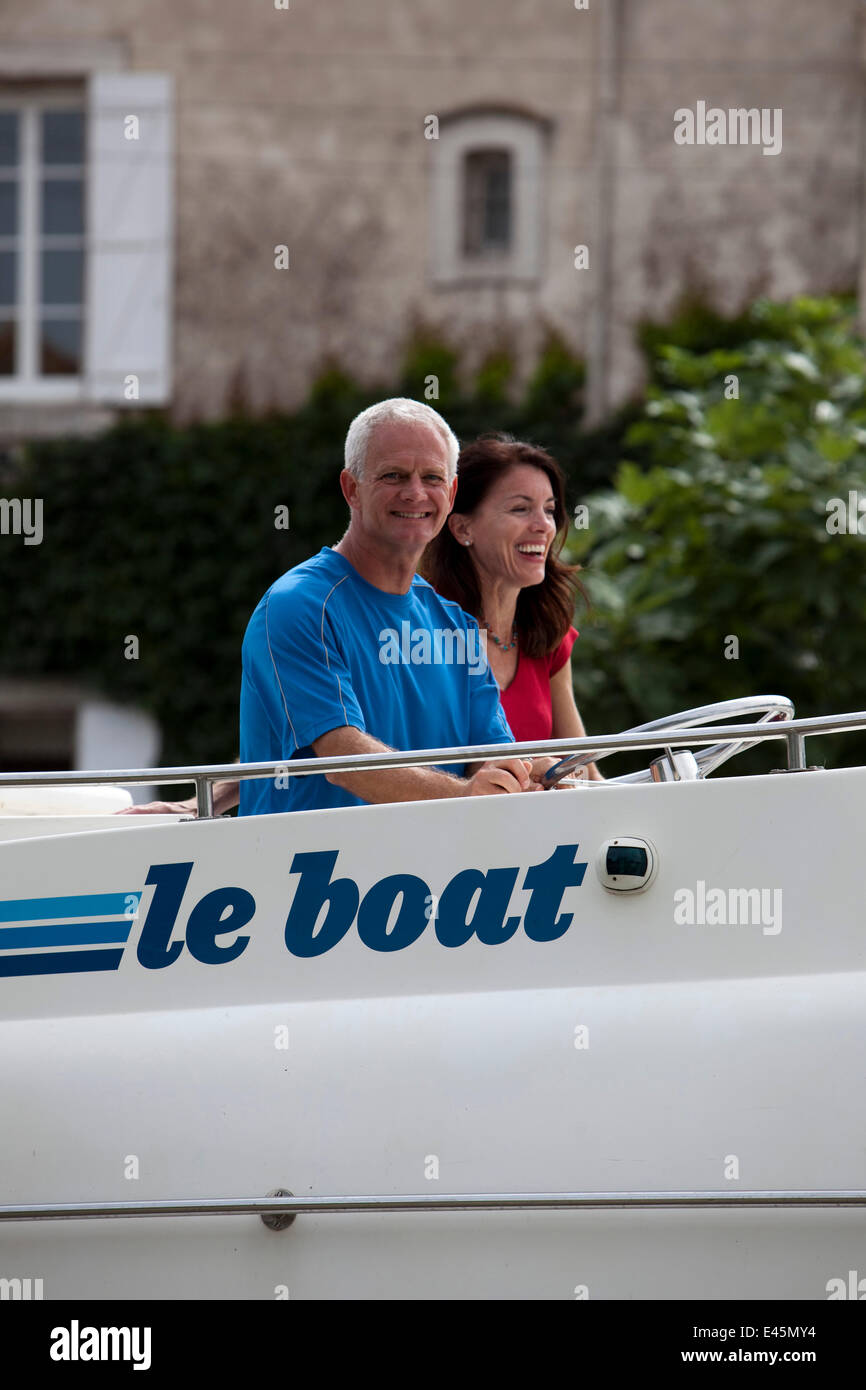Family cruising on the Canal Du Midi, Le Somail, France. July 2009. Model and property released. Stock Photo