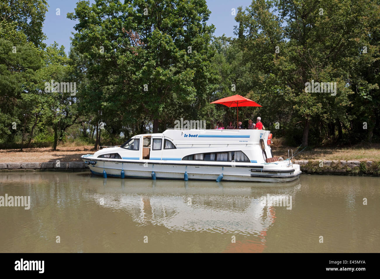 Family cruising on the Canal Du Midi near Pechlairier, southern France. July 2009. Model and property released. Stock Photo