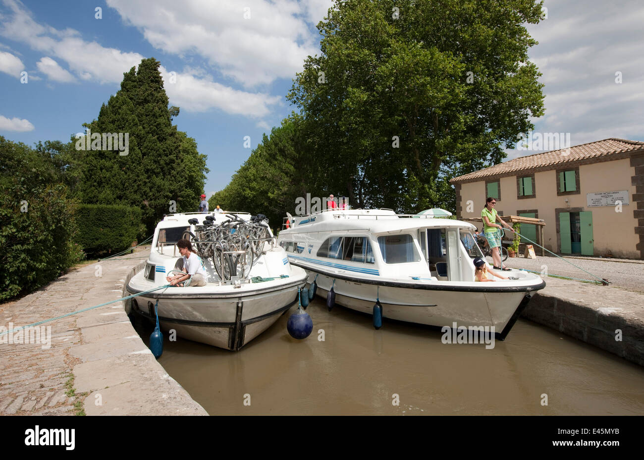 Two boats moored on the Canal Du Midi, Pechlairier, southern France. July 2009. Model and property released. Stock Photo