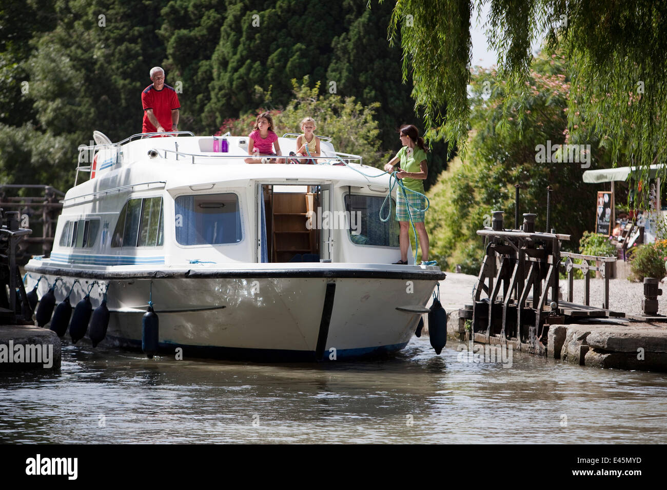 Family cruising on the Canal Du Midi near Argens-Minervois, southern France. July 2009. Model and property released. Stock Photo