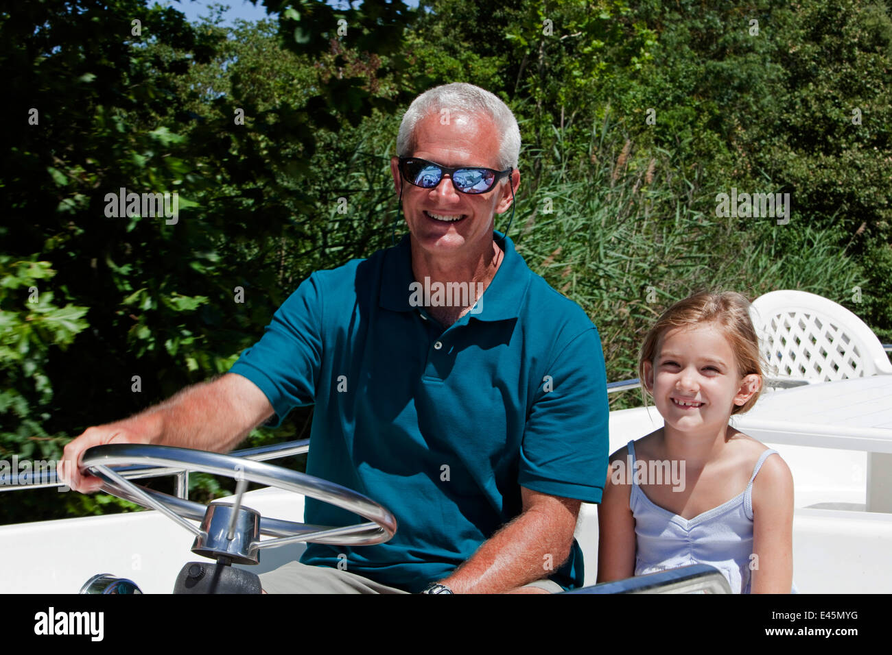 Man and girl cruising on the Canal Du Midi near Port de Bram, southern France. July 2009. Model and property released. Stock Photo