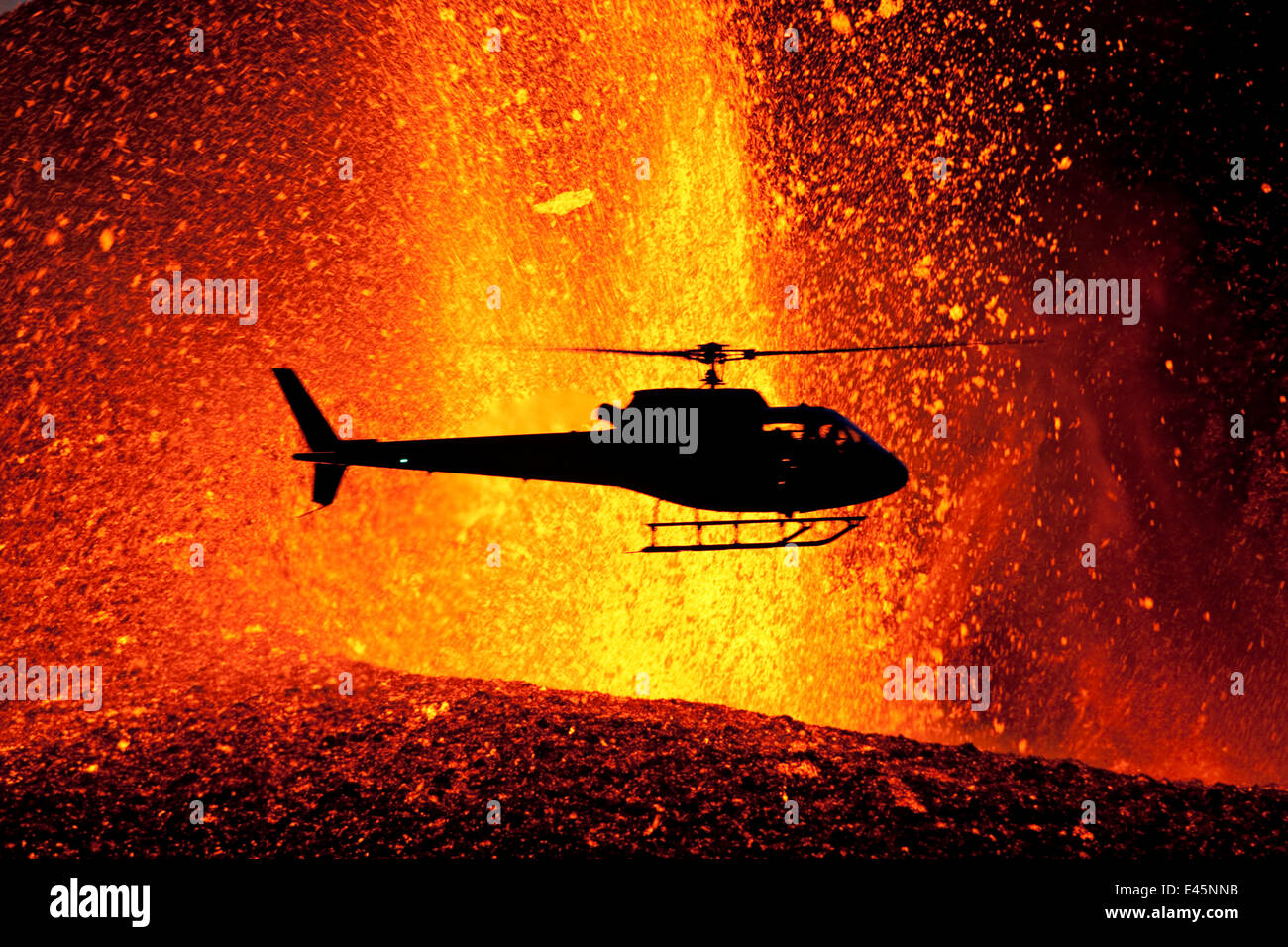 Helicopter flying over volcanic eruption near Eyjafjallajoekull glacier, Iceland, 24th March 2010. Volcano previously dormant since 1821. Stock Photo