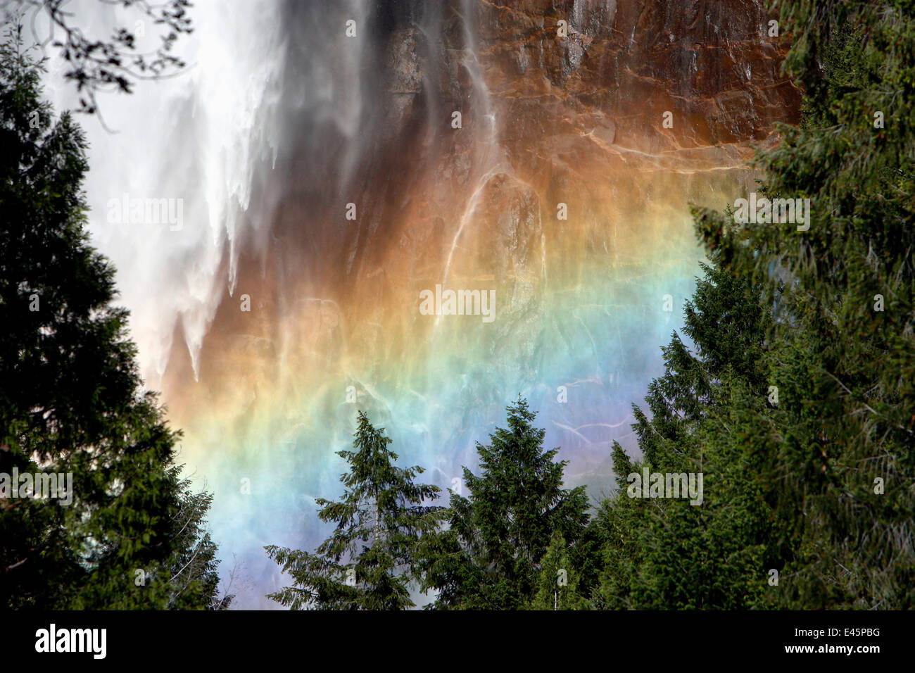 Sunlight creating a rainbow in the spray of the Bridalveil Falls, Yosemite National Park, California, USA, June 2008 Stock Photo