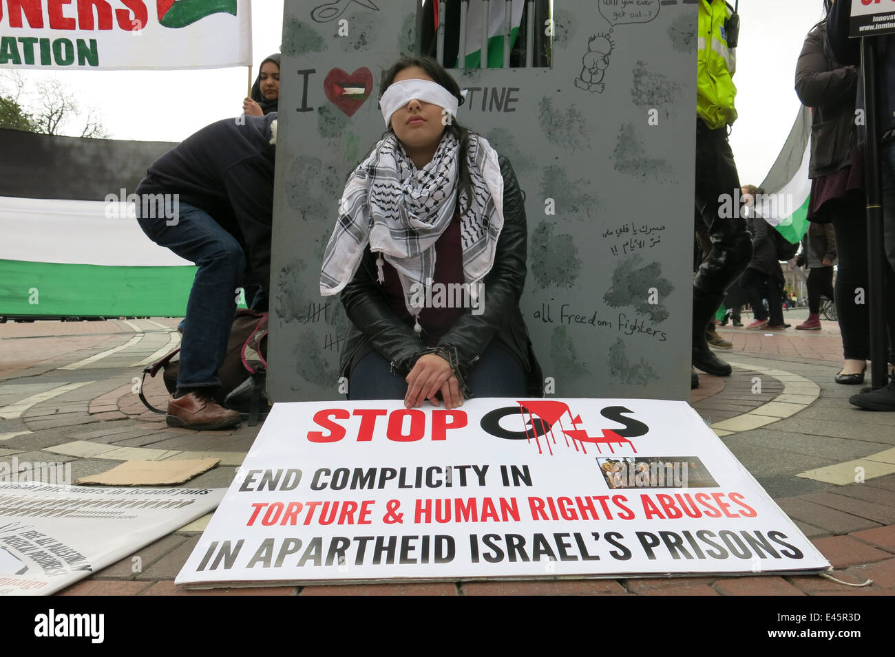 Nessrin Zavai in handcuffs and blindfolded demonstrates at a protest against G4S private security firm by the IPSC Stock Photo