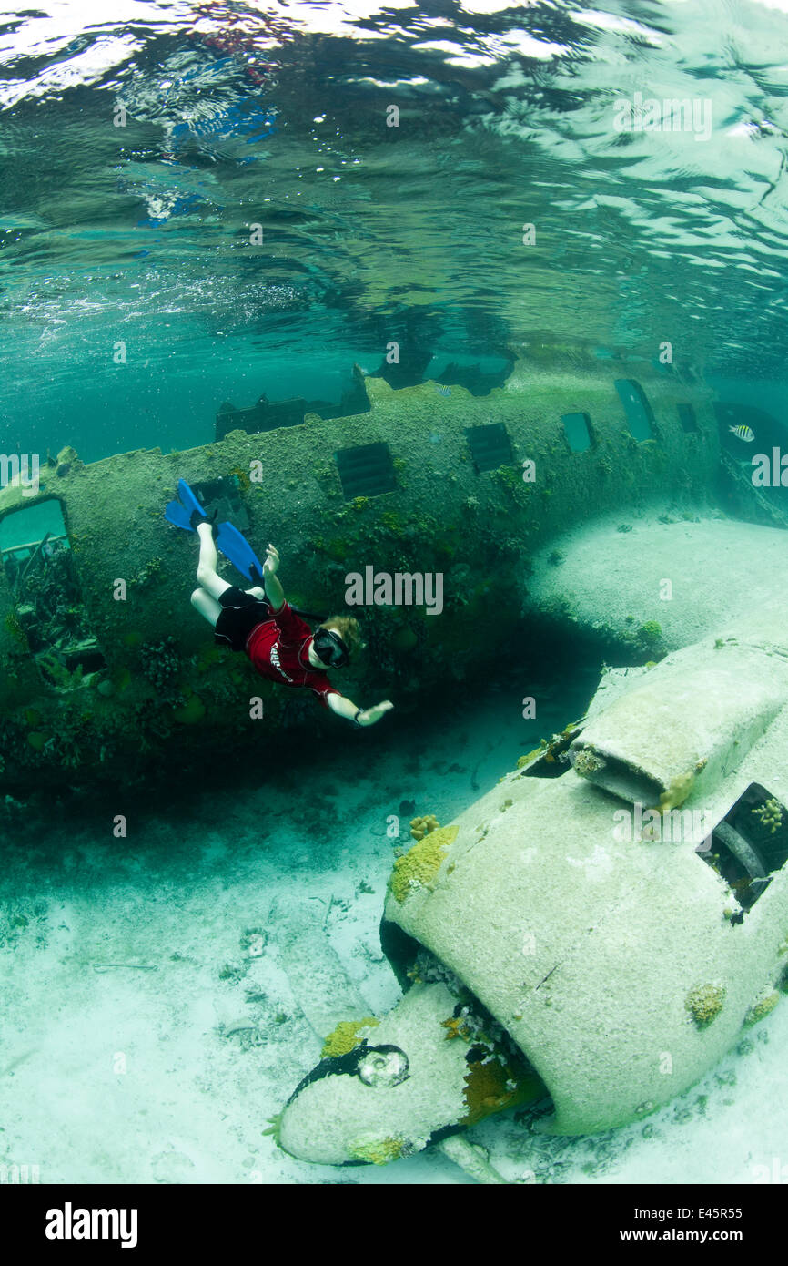 Boy exploring plane wreckage in Exumas, Bahamas, Caribbean. June 2009, model released. Stock Photo