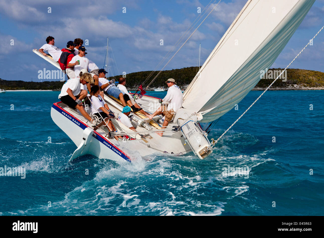 Crew riding the pry (hiking board/plank) during the Bahamian Sloop