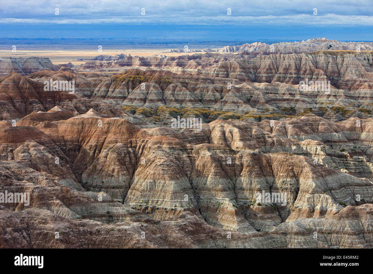 View of Badlands National Park, with shadows cast between mountain peaks, and sediment layers visible, South Dakota, USA. September 2009. Stock Photo