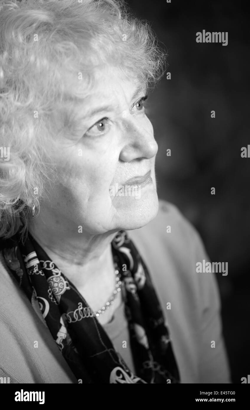 A black and white side view portrait of a senior woman. Stock Photo