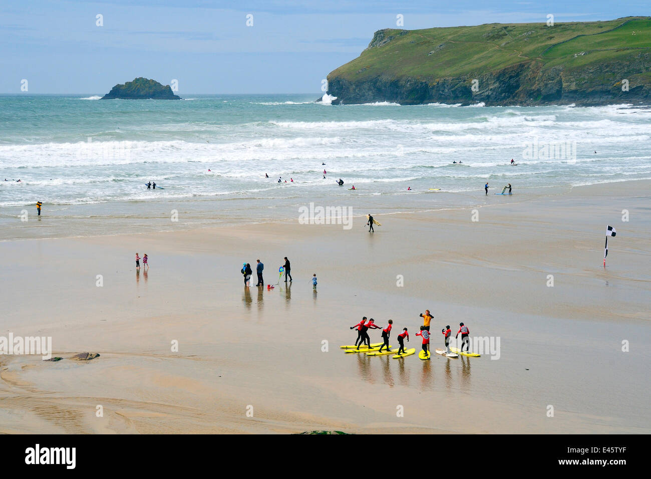 Surf school practising balancing on surf boards on the beach before entering the sea. Polzeath, north Cornwall, UK, April 2010. Stock Photo